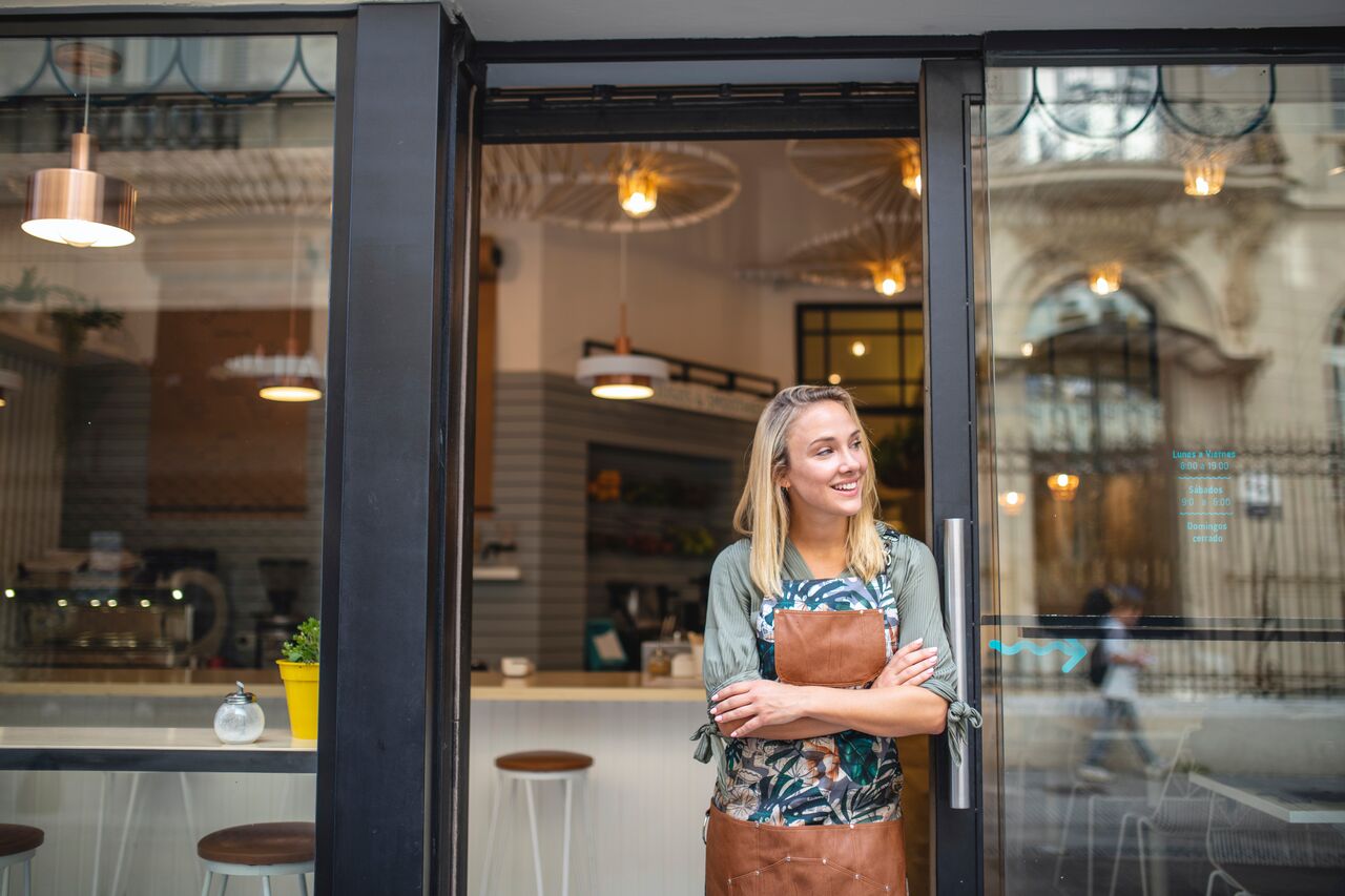 Templafy-Young Cafe Owner Standing with Arms Crossed at Front Door_GettyImages-1191194146 (1)